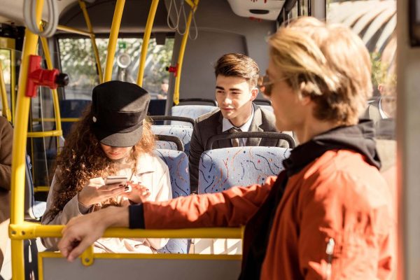 group of young people riding in public transport